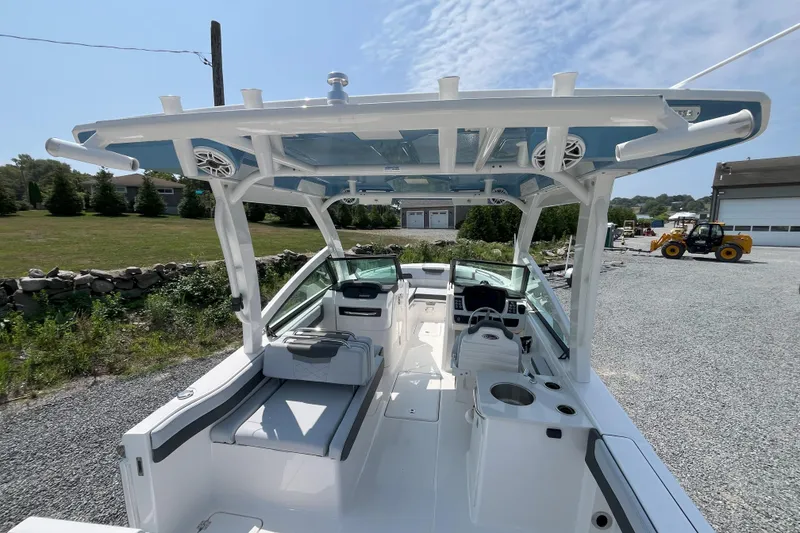 Slide: The Image of 2026 Robalo R257 Dual Console boat with spacious seating and modern helm, parked outdoors. - 7