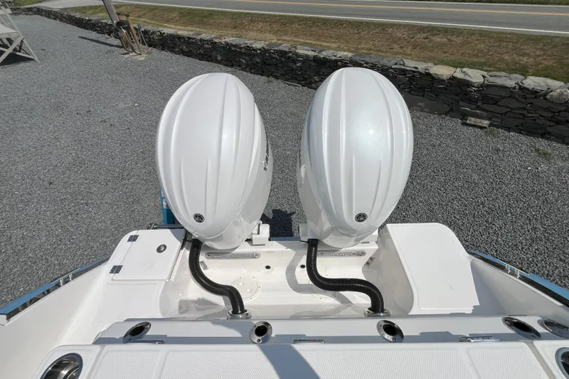 Slide: The Image of 2026 Robalo R257 Dual Console with twin outboard engines, viewed from above. - 8