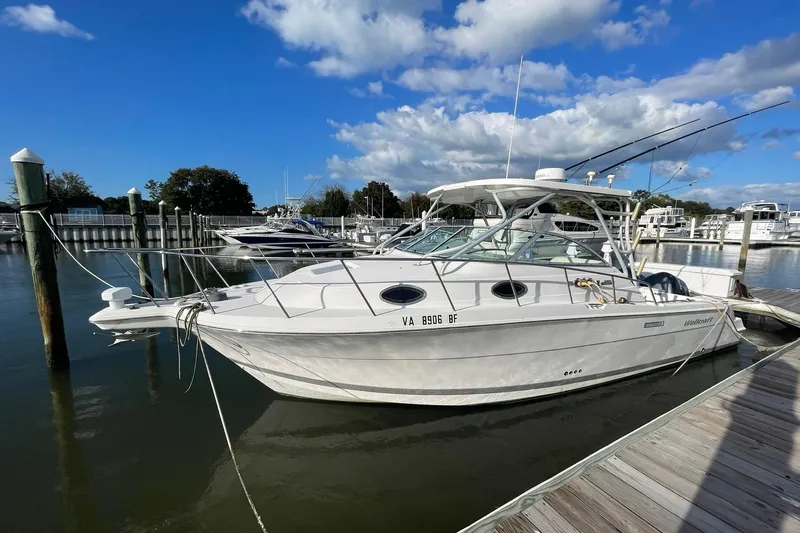 Slide: The Image of 2005 Wellcraft 290 Coastal boat docked at marina under blue sky. - 1
