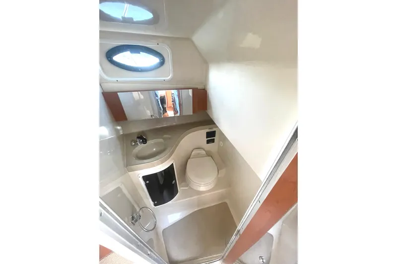 Slide: The Image of 2005 Wellcraft 290 Coastal boat bathroom with sink, toilet, and mirror. - 12