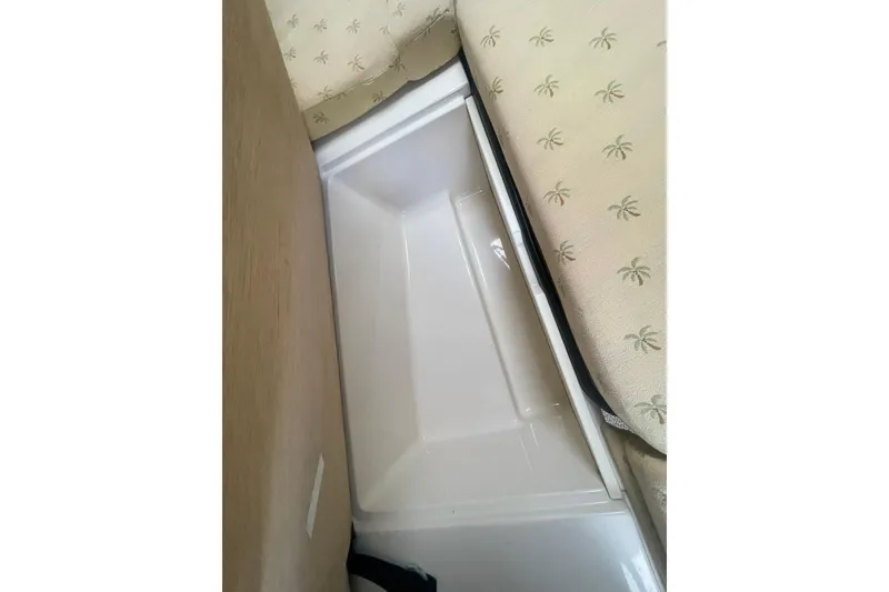 Slide: The Image of Storage compartment in 2005 Wellcraft 290 Coastal boat, with palm-patterned cushions. - 14