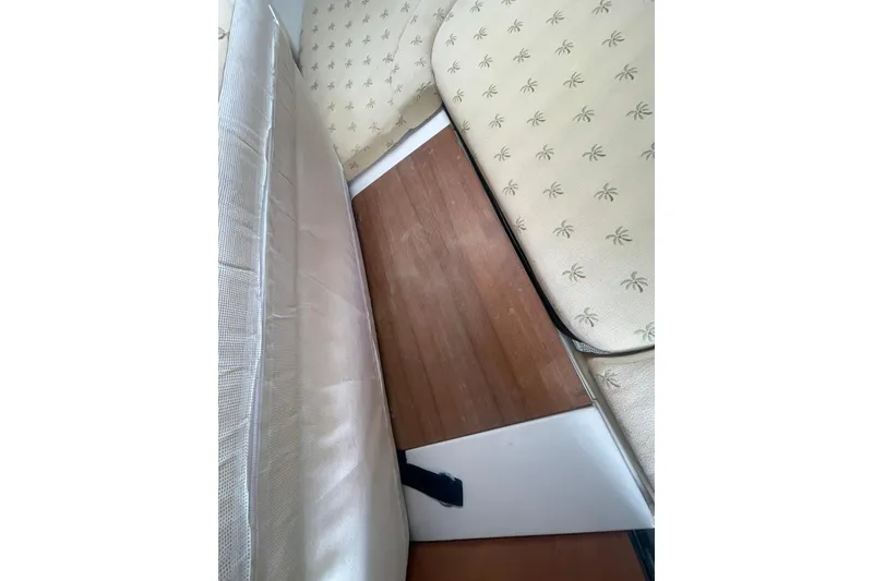 Slide: The Image of Interior view of 2005 Wellcraft 290 Coastal boat with cushioned seating and wooden flooring. - 15