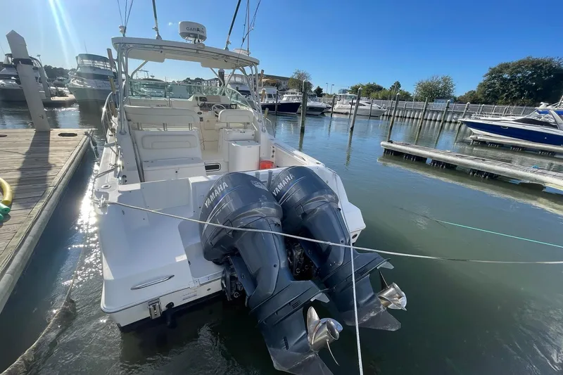 Slide: The Image of 2005 Wellcraft 290 Coastal boat docked, featuring dual Yamaha outboard engines. - 3