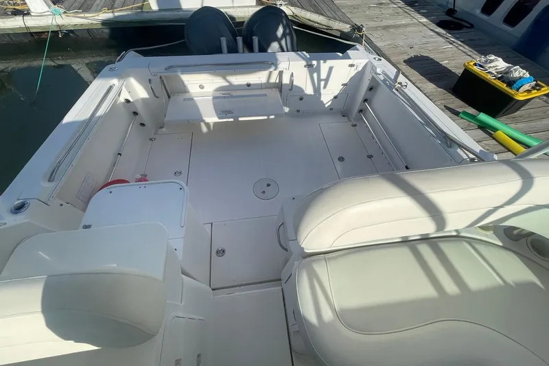 Slide: The Image of 2005 Wellcraft 290 Coastal boat interior with white seating and spacious deck area. - 35