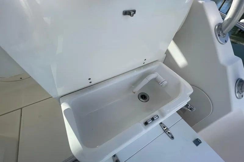Slide: The Image of 2005 Wellcraft 290 Coastal boat sink with faucet in white interior. - 40