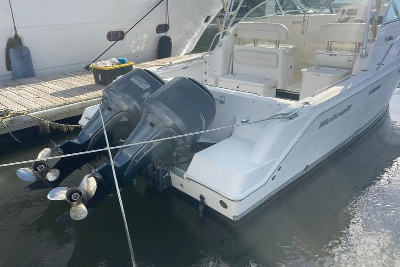 Slide: The Image of 2005 Wellcraft 290 Coastal boat with dual outboard motors docked at marina. - 46
