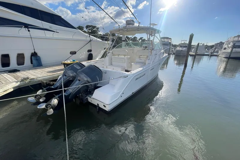Slide: The Image of 2005 Wellcraft 290 Coastal boat docked in a sunny marina. - 47