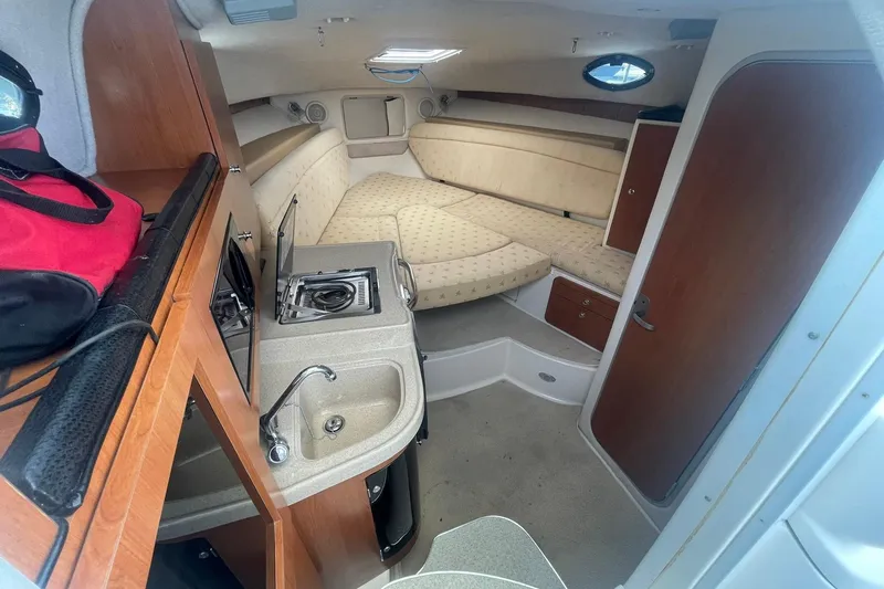 Slide: The Image of 2005 Wellcraft 290 Coastal cabin interior with kitchenette and seating area. - 5