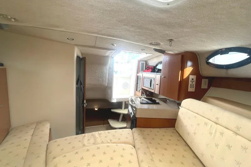 Slide: The Image of 2005 Wellcraft 290 Coastal cabin interior with kitchenette and seating area. - 7