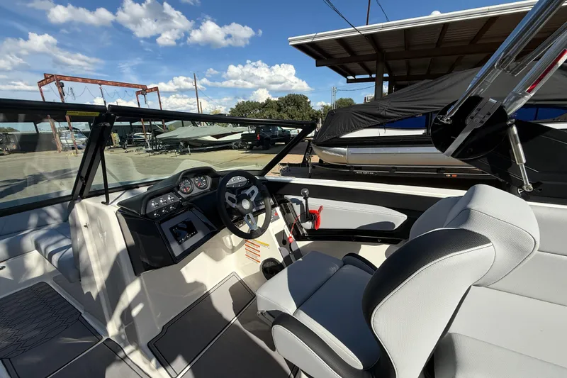 Slide: The Image of 2023 MasterCraft NXT24 boat interior with steering wheel and dashboard controls. - 10