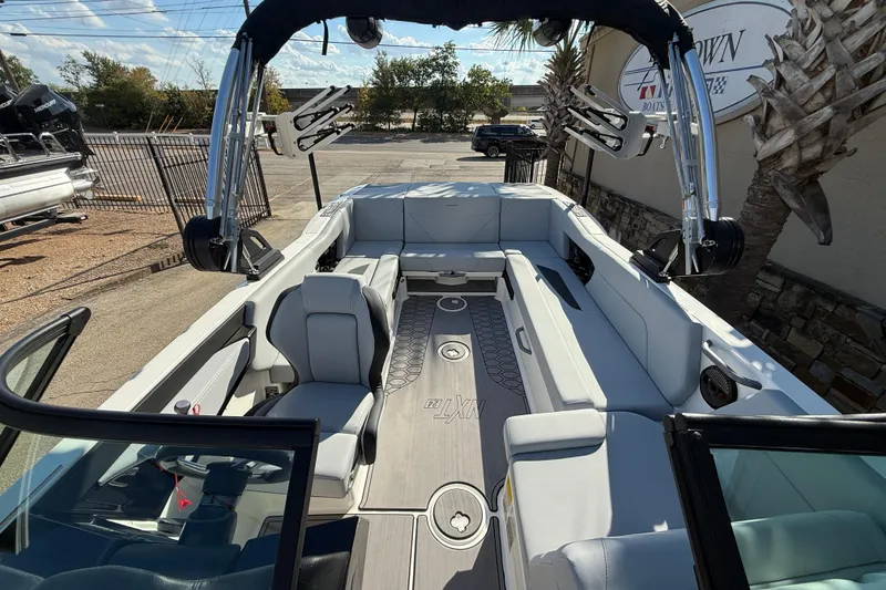 Slide: The Image of 2023 MasterCraft NXT24 boat interior with spacious seating and modern design. - 14
