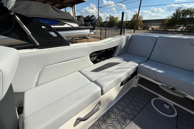 Slide: The Image of 2023 MasterCraft NXT24 boat interior with gray seating and modern design. - 15