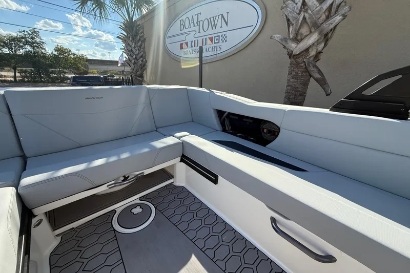 Slide: The Image of 2023 MasterCraft NXT24 boat interior with sleek seating and modern design. - 16