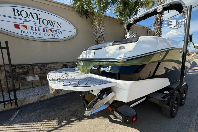 Slide: The Image of 2023 MasterCraft NXT24 boat at Boat Town dealership, showcasing sleek design and modern features. - 5