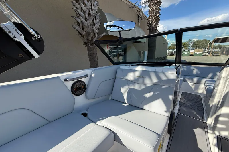 Slide: The Image of 2023 MasterCraft NXT24 boat interior with white seating and modern design. - 9