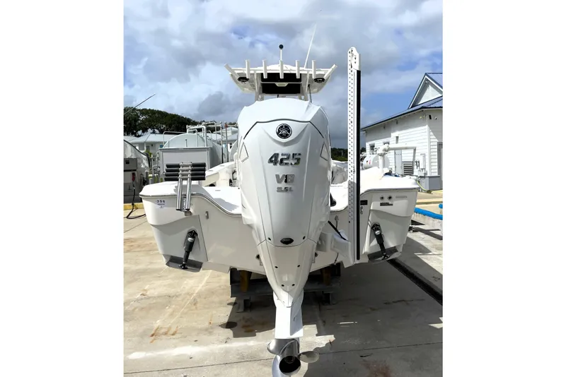 Slide: The Image of 2019 Blue Wave 2800 Pure Hybrid boat with powerful 425 V8 engine, docked outdoors. - 10