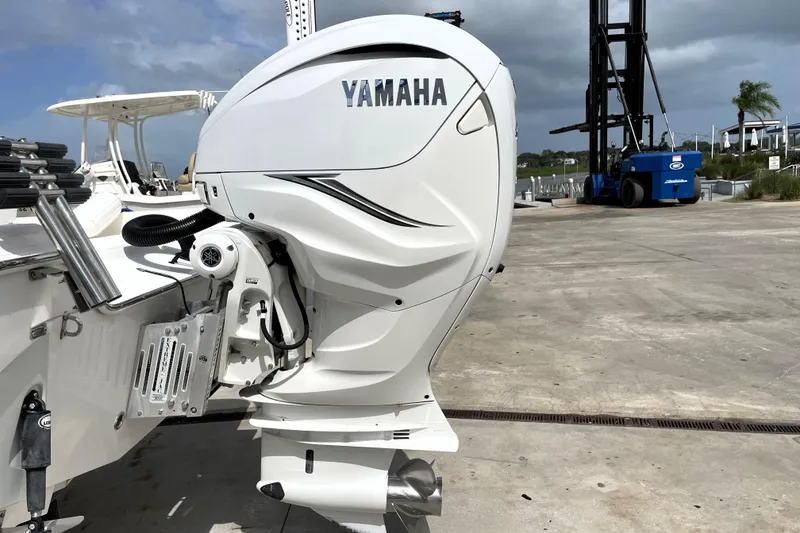Slide: The Image of 2019 Blue Wave 2800 Pure Hybrid boat with Yamaha outboard motor in marina setting. - 14