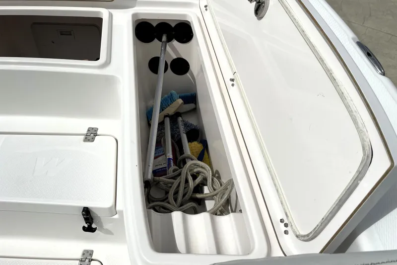 Slide: The Image of Storage compartment of 2019 Blue Wave 2800 Pure Hybrid boat with cleaning tools and rope. - 30