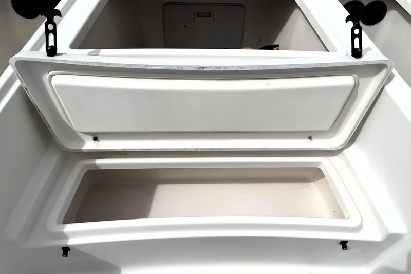 Slide: The Image of Open storage compartment on a 2019 Blue Wave 2800 Pure Hybrid boat. - 31