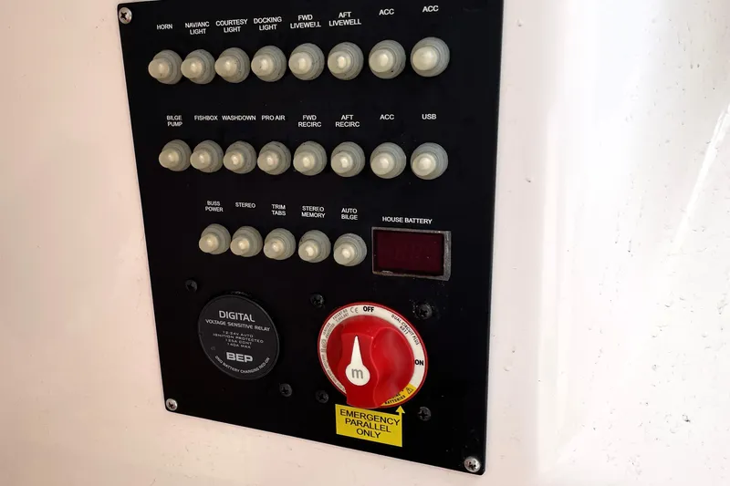 Slide: The Image of Control panel of a 2019 Blue Wave 2800 Pure Hybrid boat with various switches and battery controls. - 41