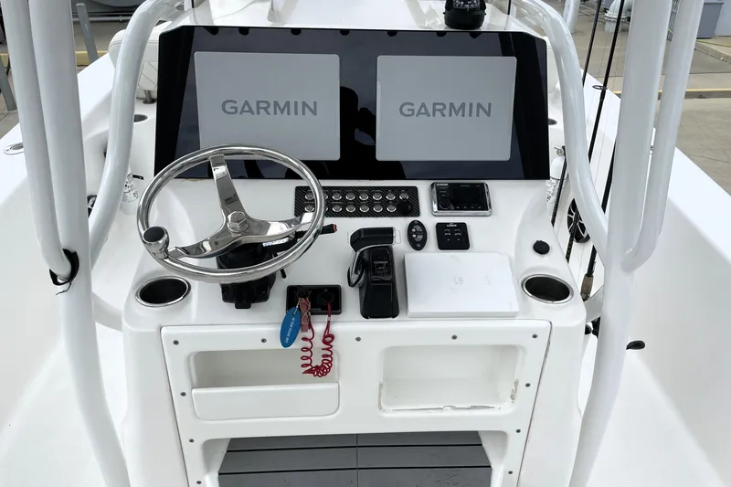 Slide: The Image of 2019 Blue Wave 2800 Pure Hybrid boat console with Garmin displays and steering wheel. - 45