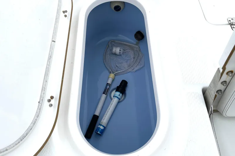 Slide: The Image of Livewell in 2019 Blue Wave 2800 Pure Hybrid boat with fishing net and tools. - 55