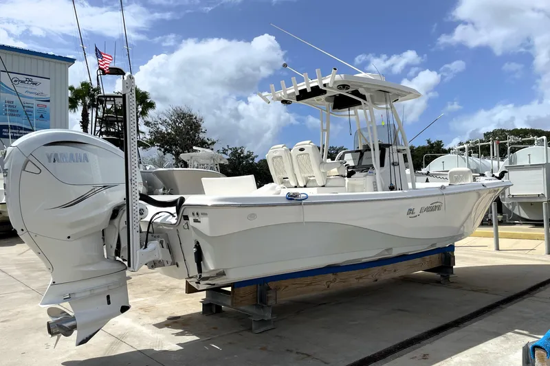 Slide: The Image of 2019 Blue Wave 2800 Pure Hybrid boat with Yamaha engine on display at a marina. - 6