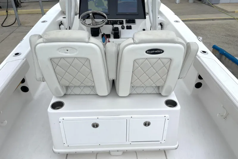 Slide: The Image of 2019 Blue Wave 2800 Pure Hybrid boat interior with dual white seats and control panel. - 60