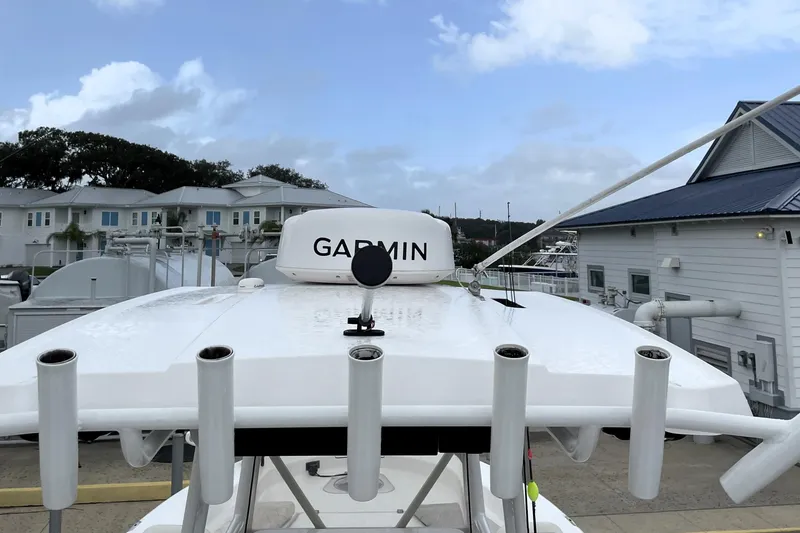 Slide: The Image of 2019 Blue Wave 2800 Pure Hybrid boat with Garmin equipment, docked near buildings. - 61