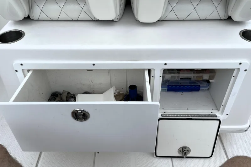 Slide: The Image of Storage compartments on a 2019 Blue Wave 2800 Pure Hybrid boat, featuring open drawers and seating. - 62