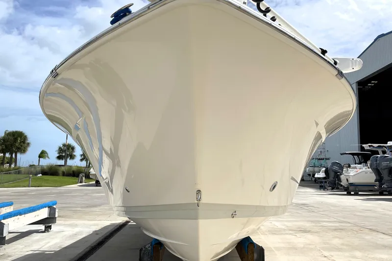 Slide: The Image of 2019 Blue Wave 2800 Pure Hybrid boat in marina, front view. - 8