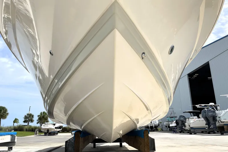 Slide: The Image of 2019 Blue Wave 2800 Pure Hybrid boat hull in a marina setting. - 9