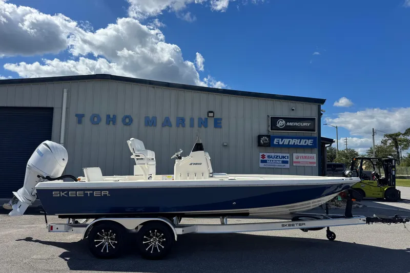 The Image of 2026 Skeeter SX221 boat at Toho Marine dealership under a blue sky. - 1
