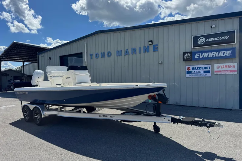 Slide: The Image of 2026 Skeeter SX221 boat on trailer at Toho Marine dealership. - 11