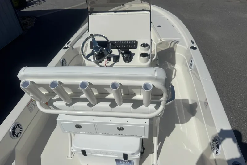 Slide: The Image of 2026 Skeeter SX221 boat interior with steering console and rod holders. - 14