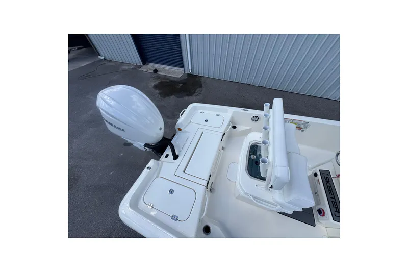 Slide: The Image of 2026 Skeeter SX221 boat with Yamaha outboard motor, featuring rod holders and storage compartments. - 19