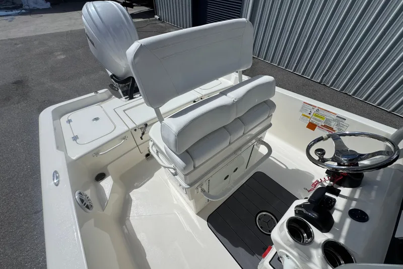 Slide: The Image of 2026 Skeeter SX221 boat interior with white seating and steering wheel. - 22