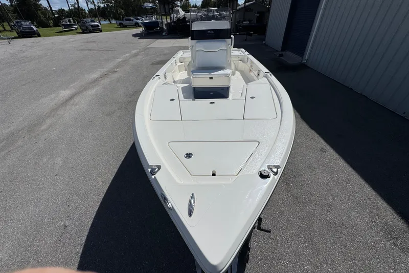 Slide: The Image of 2026 Skeeter SX221 boat parked outdoors, showcasing sleek design and spacious deck. - 4