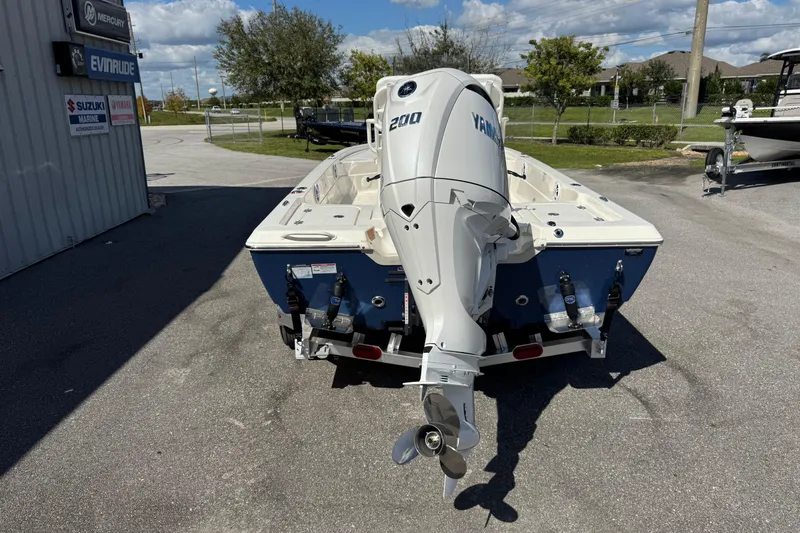 Slide: The Image of 2026 Skeeter SX221 boat with Yamaha 200 outboard motor, parked outdoors. - 8