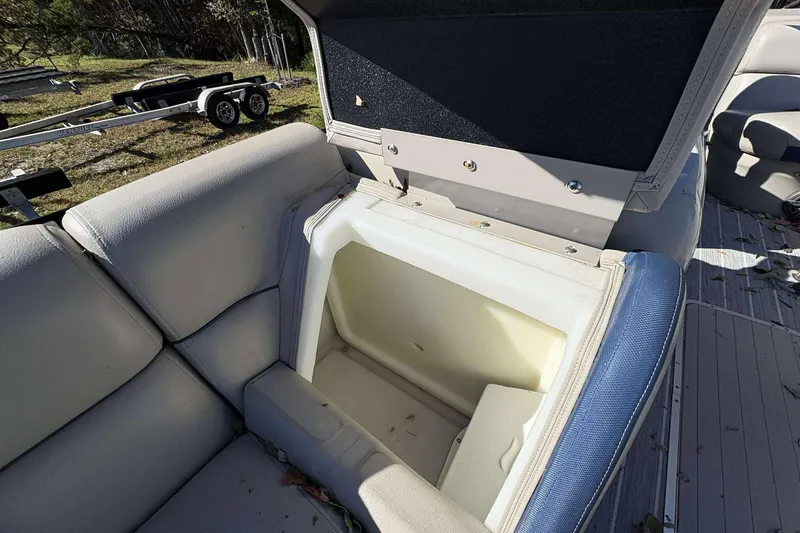 Slide: The Image of Open storage compartment in a 2017 Berkshire 23 boat seat. - 14