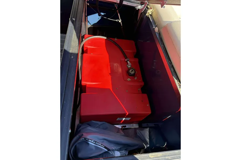 Slide: The Image of Red fuel tank in a 2017 Berkshire 23 boat compartment. - 17