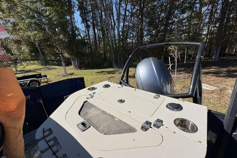 Slide: The Image of 2017 Berkshire 23 boat with outboard motor in wooded area. - 22