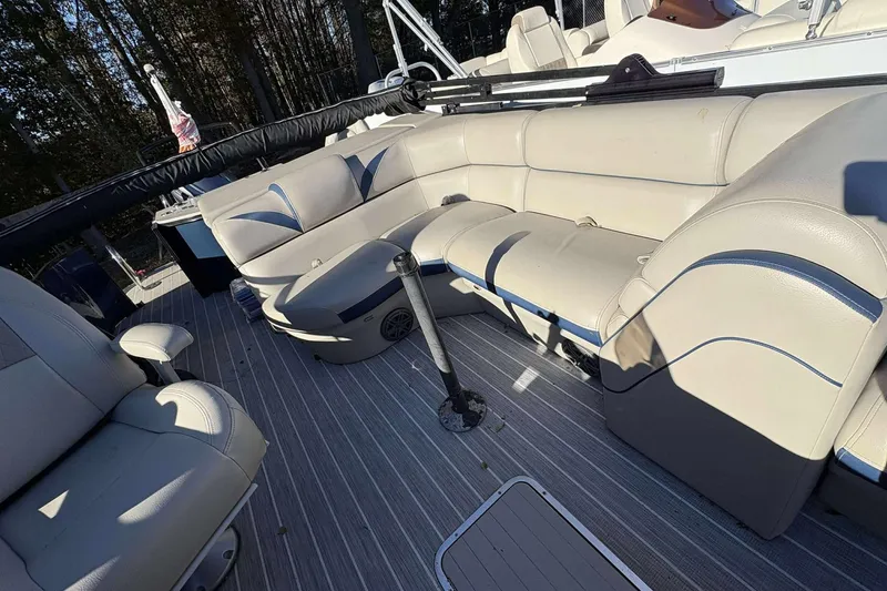 Slide: The Image of Interior of a 2017 Berkshire 23 boat with beige seating and striped flooring. - 26