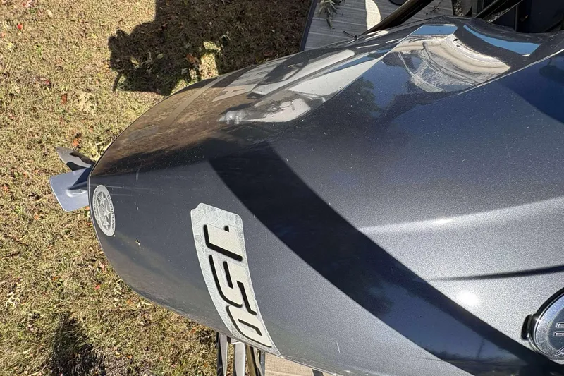 Slide: The Image of Close-up of a 2017 Berkshire 23 boat hull with logo, on grass. - 29