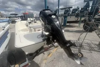 Slide: The Image of 2022 Mako Pro Skiff 15 CC boat with outboard motor, docked at marina. - 4