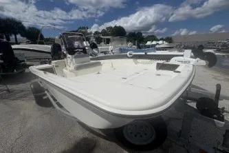 Slide: The Image of 2022 Mako Pro Skiff 15 CC boat on trailer under cloudy sky. - 6