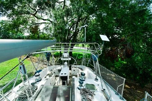 Slide: The Image of Sailboat Jeanneau Sun Odyssey 42.2, 1999 model, anchored in clear blue waters. - 2