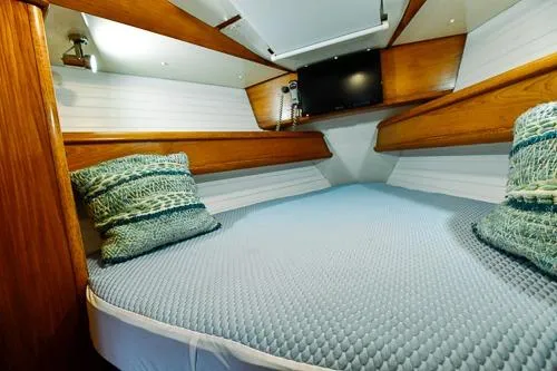 Slide: The Image of Cozy cabin interior of 1999 Jeanneau Sun Odyssey 42.2 sailboat with striped pillows. - 22