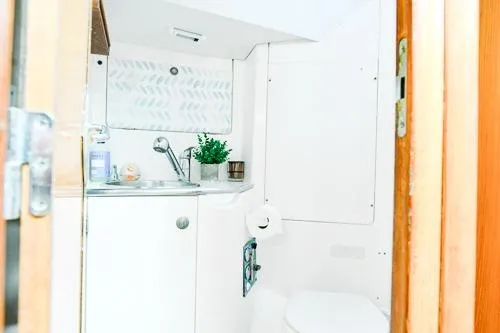 Slide: The Image of 1999 Jeanneau Sun Odyssey 42.2 cabin interior with cozy bedding and wooden finishes. - 24