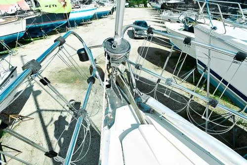 Slide: The Image of Jeanneau Sun Odyssey 42.2 sailboat docked in a serene, wooded area, 1999 model. - 3